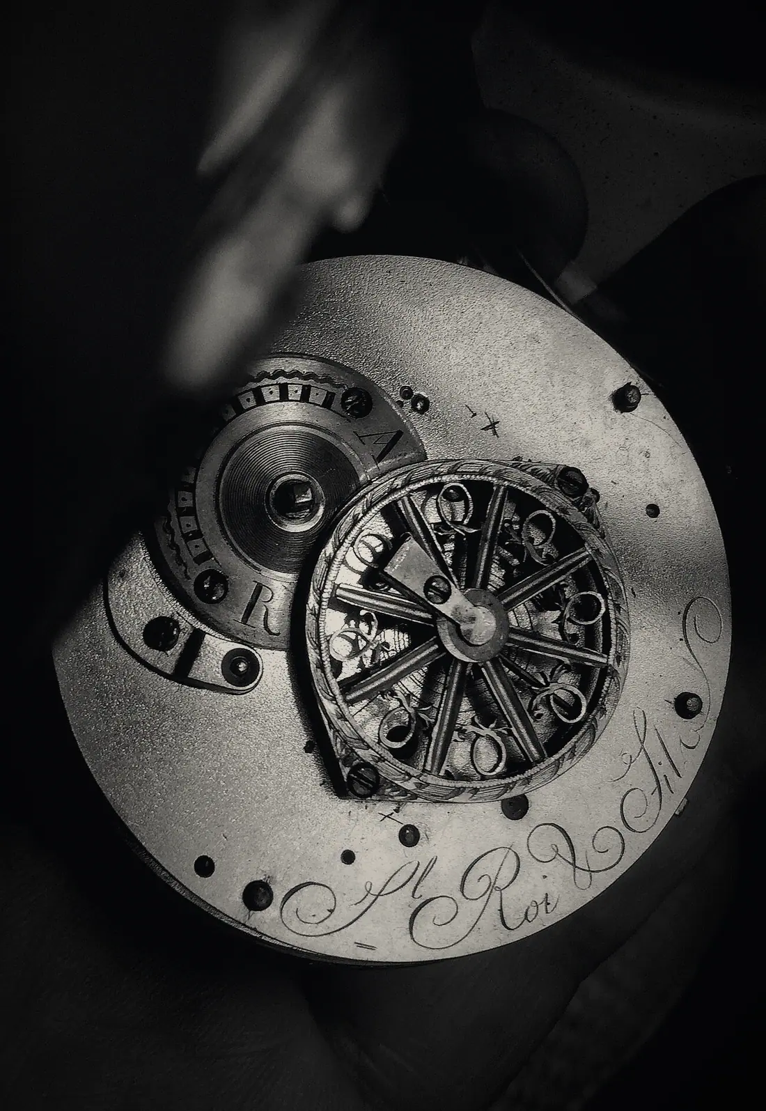 V-03 ATELIER: a hand-engraved movement in rose gold, held in the hand.