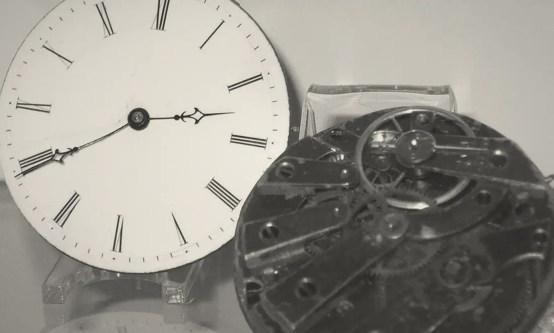 V-02 MERIDIAN: an ivory enamel dial with blued steel hands beside its movement.