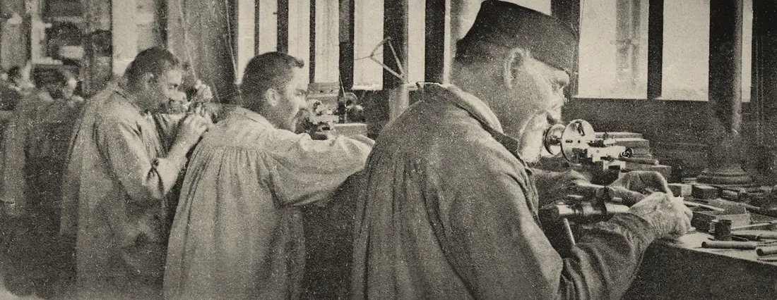 Watchmakers at their benches in a Swiss atelier, photographed in 1903.